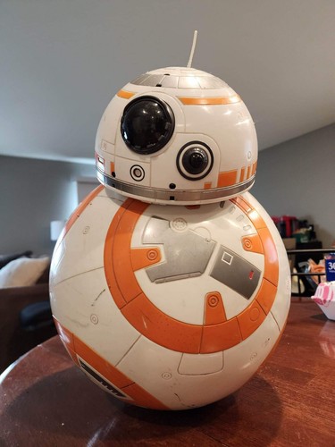 A BB-8 droid sitting on a table, standing in for the droid exploring a planet.